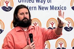 Man in front of United Way logos Supporting local agencies through grants